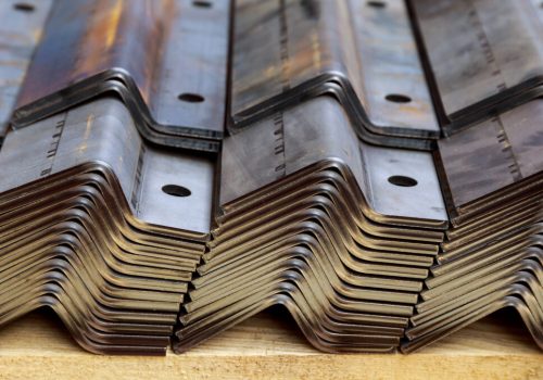 A stack of sheet metal products after processing on a bending machine.